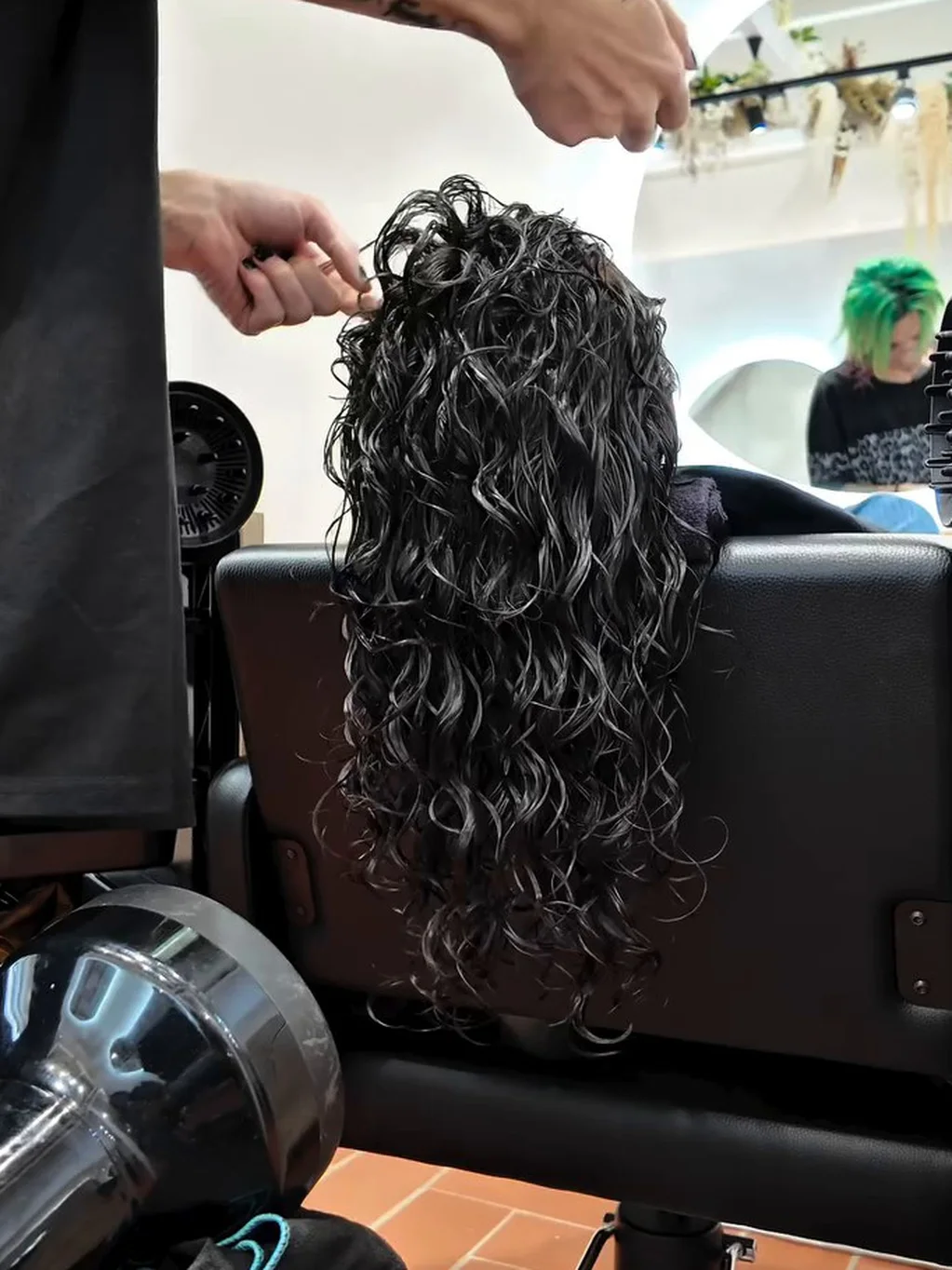 Curl definition at the salon, strand by strand with a diffuser